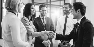 team meeting and shaking hands in corporate environment